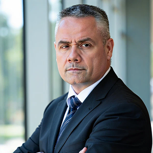 John Skaarup, Field CISO at Apollo Information Systems, in a dark suit and tie.